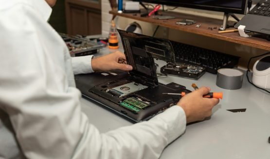 Computer repair technician repairing a laptop